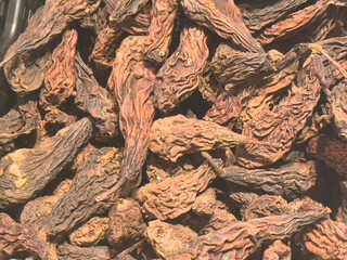 Pile of dried bitter melon gourds with wrinkled texture and earthy tones
