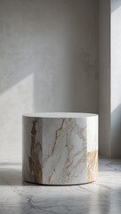 Marble cylinder pedestal. White stone podium with gold veins. Empty stand on marble floor and beige wall, indoor. Sunlight on backdrop.