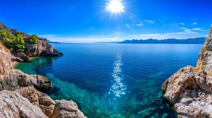 Fototapeta premium Coastal Serenity: Sunlit Seascape and Rocky Cove - Tranquil seascape, sun-drenched coast, clear blue water, rocky cliffs, summer vacation. Symbolizing peace, freedom, adventure, escape, and renewal