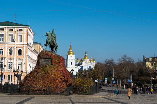 Bronze monument to Bohdan Khmelnitsky on Sofievskaya Square in autumn foliage with a view of