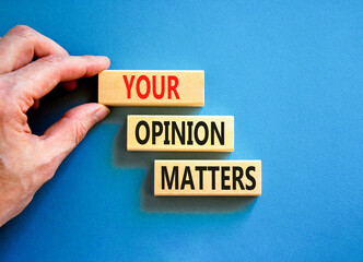 Your opinion matters symbol. Concept words Your opinion matters on beautiful wooden blocks. Beautiful blue background. Businessman hand. Business your opinion matters concept. Copy space.