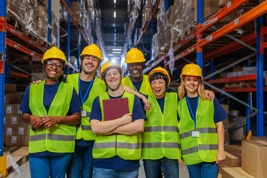 Diverse warehouse team posing together