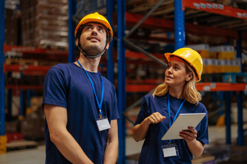 Warehouse workers inspecting storage area