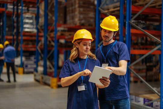 Warehouse workers talking about their daily tasks
