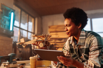 Woman carpenter working on toy design.