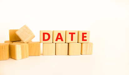 Date symbol. Concept word Date on beautiful wooden blocks. Beautiful white table white background....