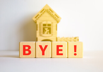 Bye symbol. Concept word Bye on beautiful wooden blocks. Beautiful white table white background. Wooden beautiful house. Business and bye concept. Copy space.
