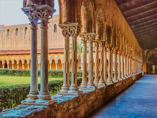 Columns in Sicilian cathedral courtyard bathed in golden light