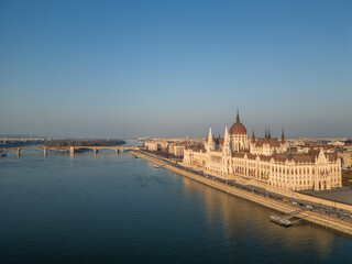Fototapeta premium Hungarian Parliament Building reflecting on Danube river in Budapest during sunny morning