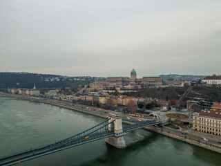 Fototapeta premium Budapest cityscape with Buda Castle and Chain Bridge crossing Danube river Aerial view