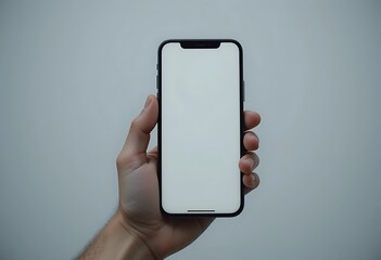 Hand holding a smartphone with a blank screen