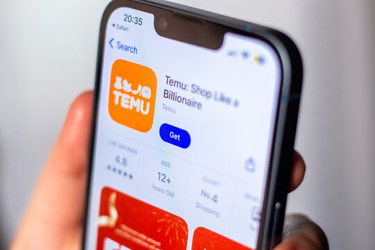 Kaliningrad, Russia 14.01.25 - Woman holding iPhone and downloading TEMU application from app store. Online shopping app