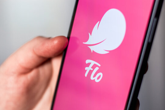 Kaliningrad, Russia 14.01.25 - Woman holding smartphone with FLO application logo on screen. Controlling woman period, ovulation, pregnancy. Female health concept.