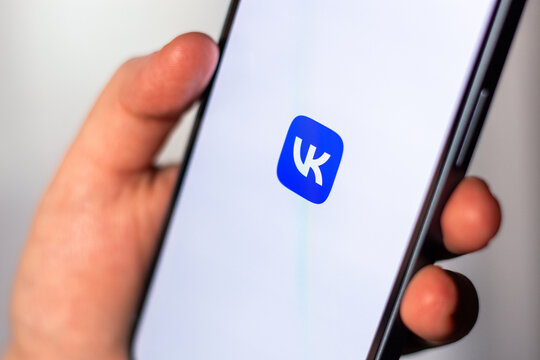 Kaliningrad, Russia 14.01.25 - Woman holding smartphone with VKONTAKTE application on screen. VK social media app.