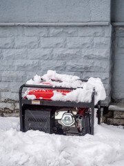 Generator outside in the snow. Backup power source in the store.