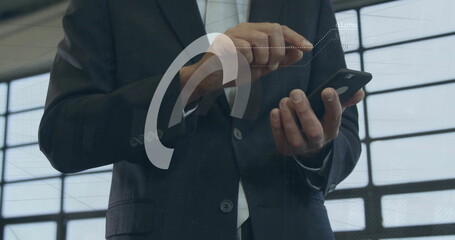 Image of financial data processing over biracial businessman using smartphone in office