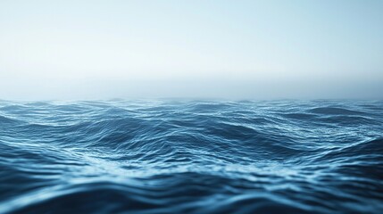 Fototapeta premium Calm ocean waters at dawn with gentle waves and a hazy horizon in soft blue tones