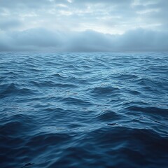 Fototapeta premium Waves gently undulate under a cloudy sky at twilight over a vast ocean expanse