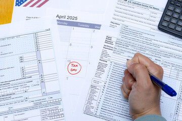 Frustrated taxpayer filling out IRS forms before the Tax Day deadline