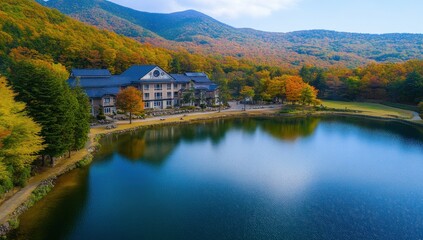 Fototapeta premium Autumnal mountain lake with lodge reflection.