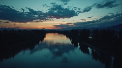 Fototapeta premium Serene River Sunset Landscape with Colorful Sky Reflection
