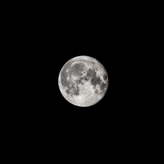 Detailed image of the full moon isolated on black.