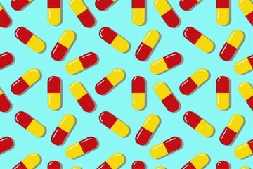 Red and yellow pills. Colorful medical pills seamless pattern. Tablets background. Capsules pattern in a blue background. A bright colored medical illustration. A seamless pattern with medical pills.