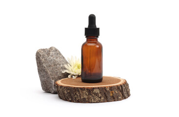 Amber glass transparent dropper bottle, flower on wooden circle podium. Minimal empty display product presentation scene.