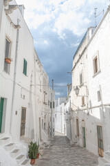 Street and clouds in Ostuni white city (Città Bianca), Puglia, Italy