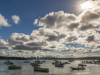Panoramic views of Sydney boats at sunset with clouds