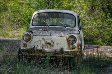 old car abandoned in nature