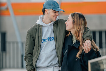couple of boy and girl on the street outdoors hugging