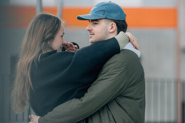 couple of boy and girl on the street outdoors hugging