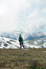 Young girl hiker in the high clouds mountains