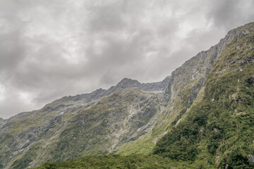Scenic nature with water, trees, mountains and clouds