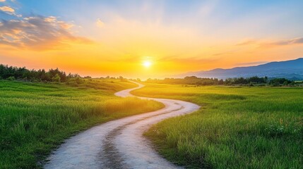 Golden rays of a sunset illuminate a winding dirt path, guiding the eye through vibrant green fields and rolling hills. Tranquility fills the air as day transforms into night