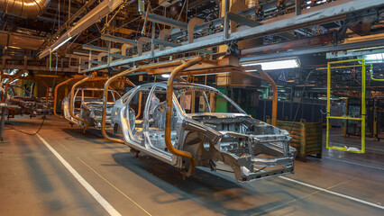 Close view of a car body on an assembly line.