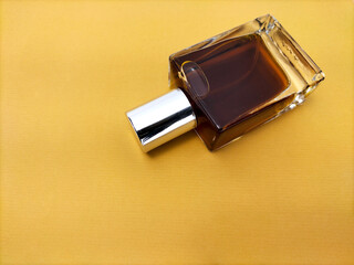 blank  glass perfume bottle on brown paper background