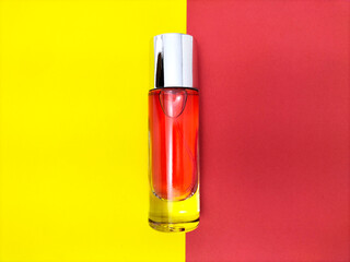 glass perfume bottle on a two-toned paper background