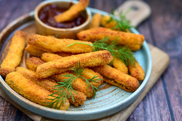  Crispy home made  deep fried   chicken strips . Breaded  with cornflakes chicken  breast fillets  with chilly peppers and fresh   basil on wooden rustic background