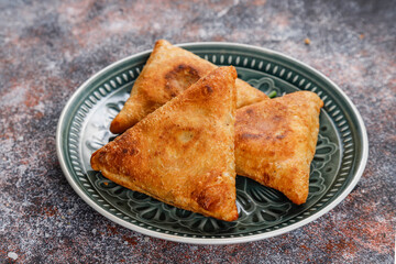 Fried samosas with vegetable filling, popular Indian snacks.