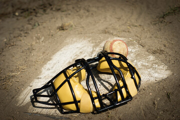 Baseball and catcher's mask on home plate