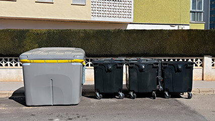 Waste management containers in residential area, highlighting urban infrastructure in Spain....