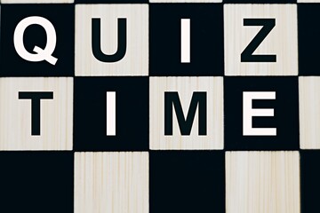 the words Quiz Time on a chessboard. The concept of answering quizzes or quiz games. text space