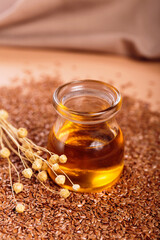 Brown linen seeds, flaxseed vegetable oil on beige background. Flaxseed background. Healthy super food