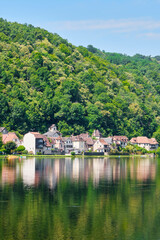 The village of Beaulieu-sur-Dordogne and the Dordogne river in Corrèze Nouvelle-Aquitaine in Southern France on a sunny day in summer