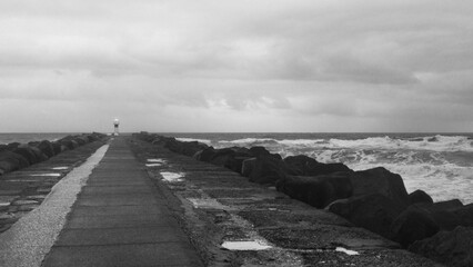 Lighthouse in distance at gold coast, black and white