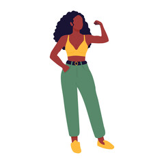 A woman in a yellow top and green pants is posing for a picture. She is standing with her arms crossed and looking straight ahead