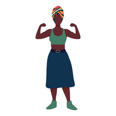 A woman with a turban and a green shirt is standing with her arms crossed. She is wearing a blue skirt and has a belt around her waist