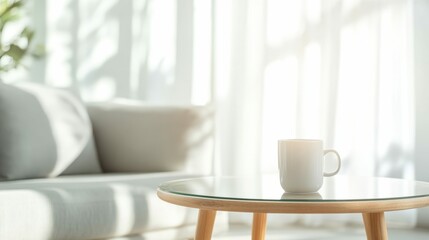 Cup of coffee on a glass table with sunlight streaming in, minimalistic living room decor in the background